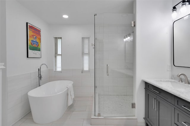 2227 Timberwood, Carrollton, TX 75006 - full bathroom featuring tile walls, vanity, tile patterned flooring, a shower stall, and a freestanding bath