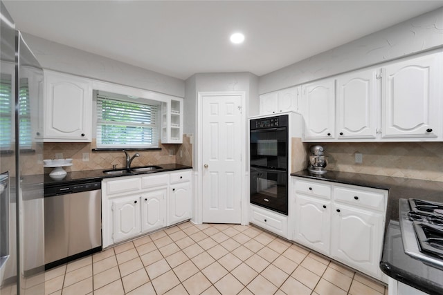 2227 Timberwood, Carrollton, TX 75006 - kitchen with a sink, dark countertops, white cabinetry, dobule oven black, and stainless steel dishwasher