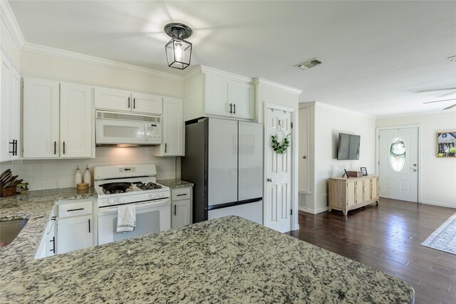 5921 Springbrook Dr, Tyler, TX 75707 - kitchen with white cabinetry, ornamental molding, white appliances, and light stone counters