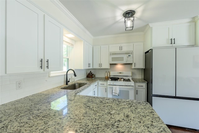 5921 Springbrook Dr, Tyler, TX 75707 - kitchen featuring a sink, white appliances, white cabinets, backsplash, and light stone counters