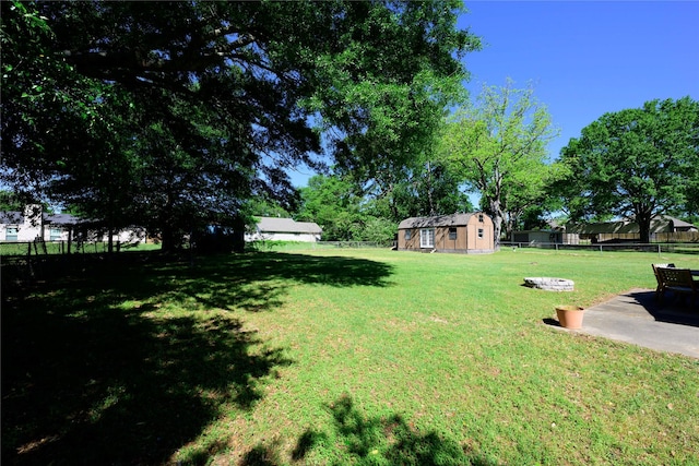 5921 Springbrook Dr, Tyler, TX 75707 - view of yard with an outdoor structure, a fenced backyard, and a patio
