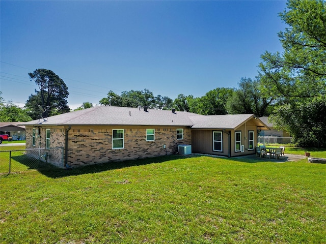 5921 Springbrook Dr, Tyler, TX 75707 - back of property with a yard, central AC unit, and fence