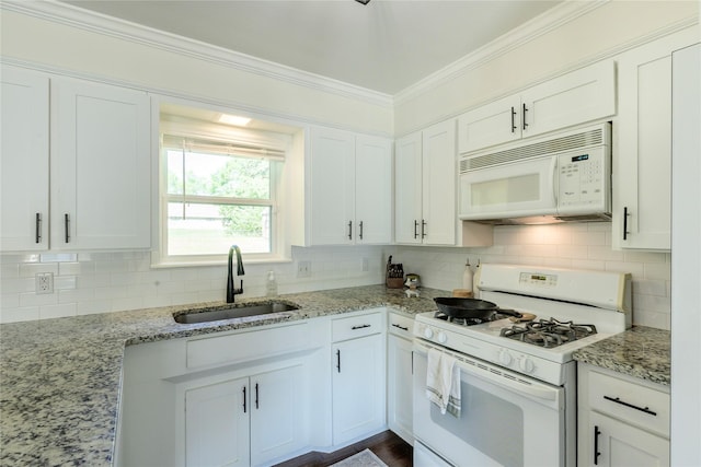5921 Springbrook Dr, Tyler, TX 75707 - kitchen with white appliances, a sink, white cabinetry, crown molding, and decorative backsplash