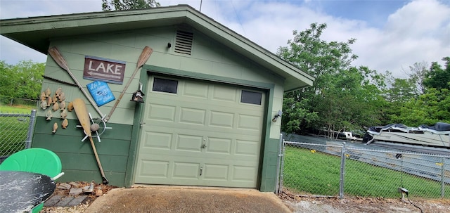 garage with driveway and fence