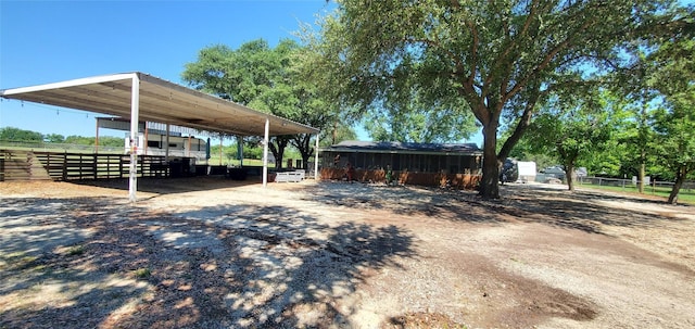 exterior space featuring fence, a carport, and driveway