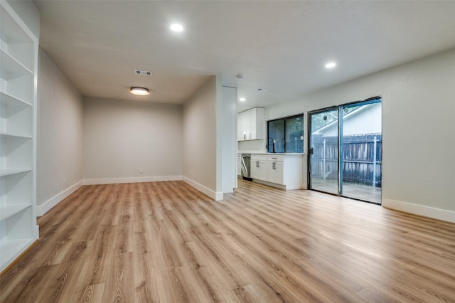 unfurnished living room featuring light wood finished floors, baseboards, and recessed lighting