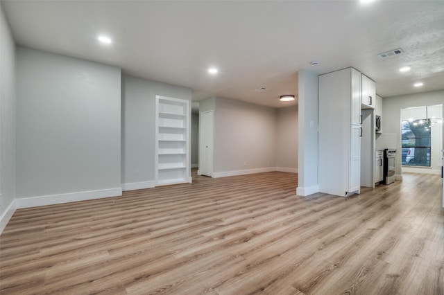 unfurnished living room with baseboards, light wood-type flooring, visible vents, and recessed lighting