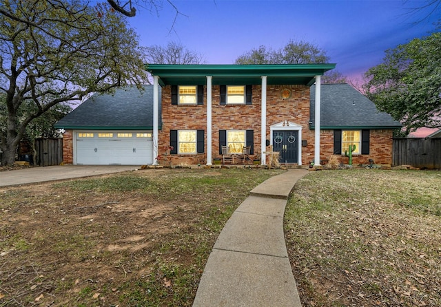 neoclassical home featuring a lawn, driveway, brick siding, fence, and a porch
