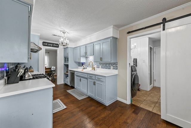 kitchen with light countertops, a sink, dishwasher, tasteful backsplash, and ornamental molding