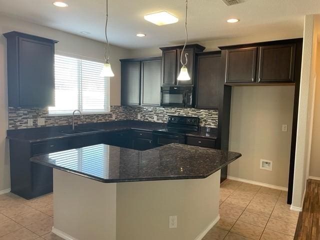 kitchen with a sink, light tile patterned flooring, black appliances, backsplash, and a kitchen island