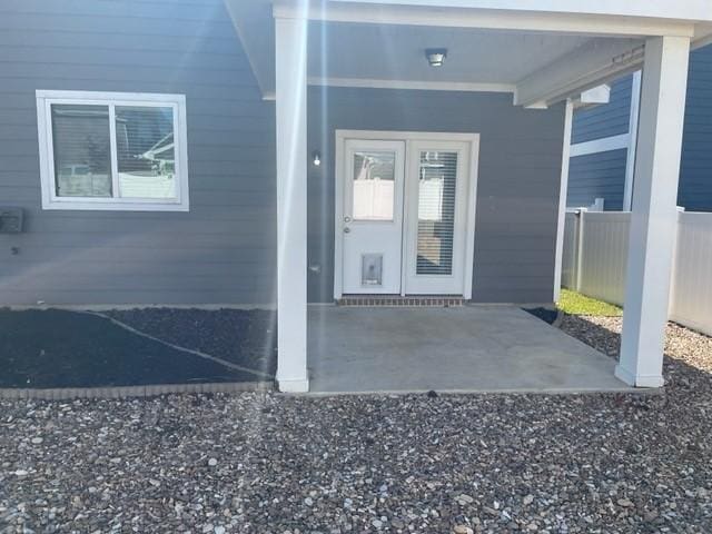 entrance to property with a patio and fence