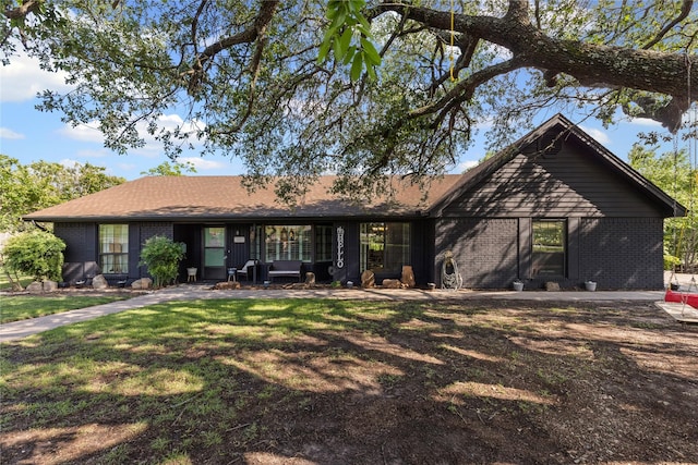 1105 Charles St, Weatherford, TX 76086 - view of front facade with brick siding and a front lawn
