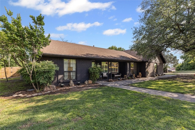 1105 Charles St, Weatherford, TX 76086 - view of front of home with brick siding and a shingled roof