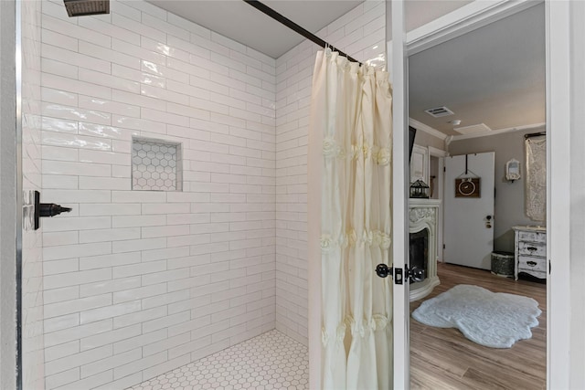 1105 Charles St, Weatherford, TX 76086 - full bath with tiled shower, wood finished floors, and crown molding