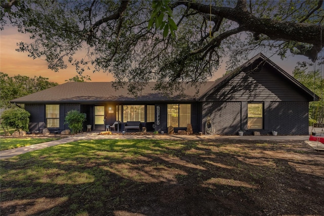 1105 Charles St, Weatherford, TX 76086 - view of front of property featuring outdoor lounge area, brick siding, a front yard, and a patio area