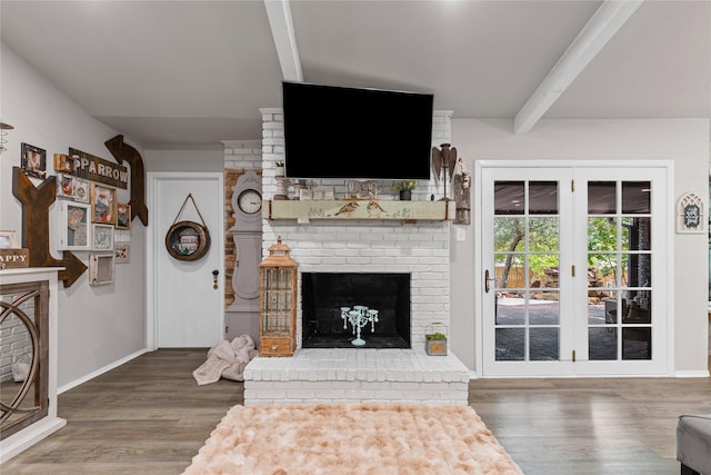 1105 Charles St, Weatherford, TX 76086 - living room featuring beamed ceiling, wood finished floors, a fireplace, and baseboards