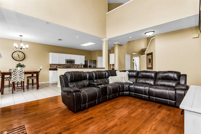 living area with recessed lighting, visible vents, light wood-style flooring, and a notable chandelier
