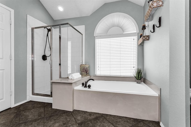full bathroom featuring vaulted ceiling, a shower stall, a bath, and tile patterned floors