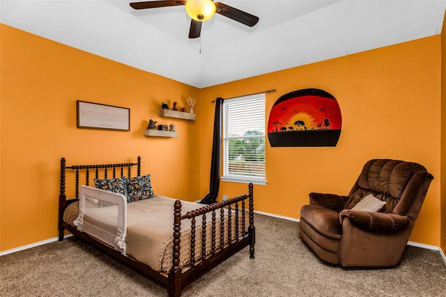 carpeted bedroom with ceiling fan and baseboards