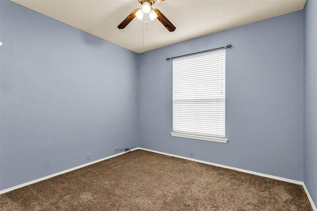 unfurnished room with carpet flooring, baseboards, a ceiling fan, and a healthy amount of sunlight