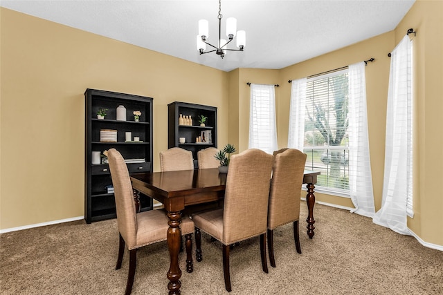 dining area with carpet flooring, a notable chandelier, and plenty of natural light