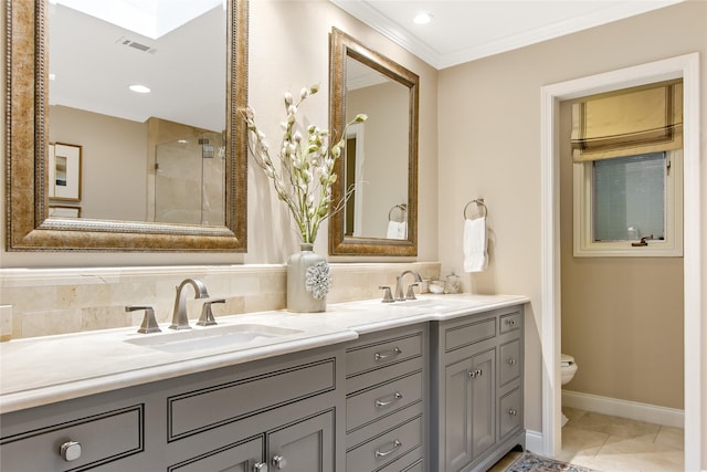bathroom featuring a sink, double vanity, toilet, and visible vents