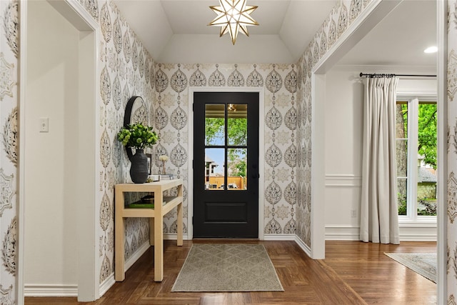 foyer with lofted ceiling, recessed lighting, a notable chandelier, baseboards, and wallpapered walls