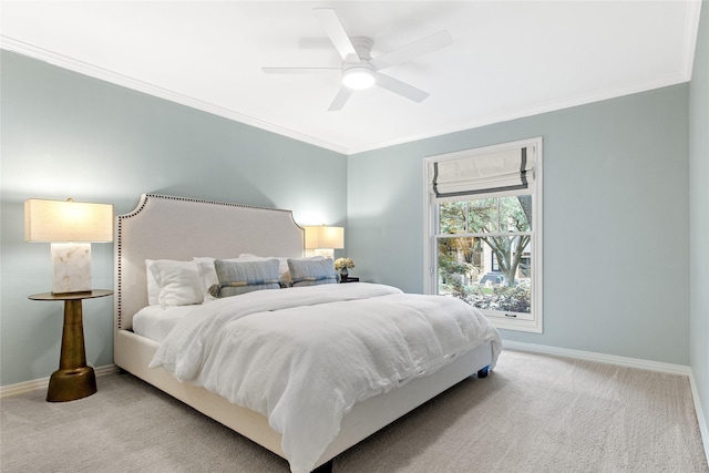 carpeted bedroom featuring crown molding, baseboards, and a ceiling fan