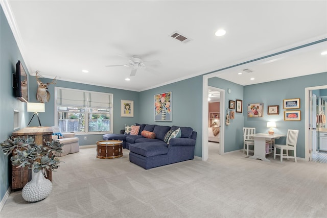 carpeted living room with baseboards, ornamental molding, and a ceiling fan