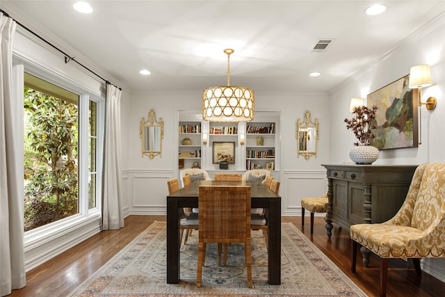 dining space featuring a decorative wall, visible vents, wood finished floors, and recessed lighting