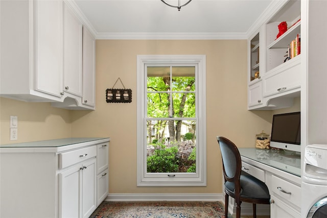 office area with baseboards, washer / dryer, crown molding, and built in study area