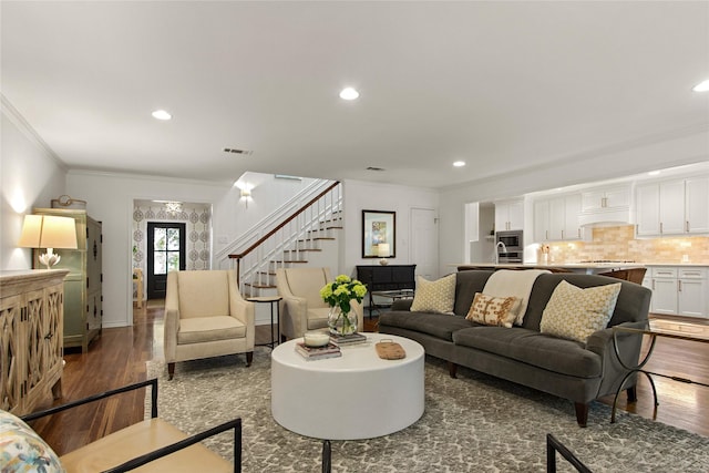 living area featuring stairs, wood finished floors, visible vents, recessed lighting, and crown molding