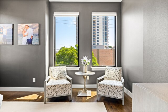sitting room with wood finished floors and baseboards