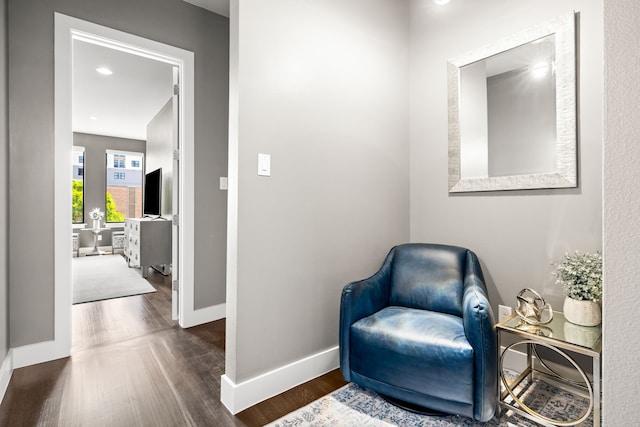living area with wood finished floors and baseboards