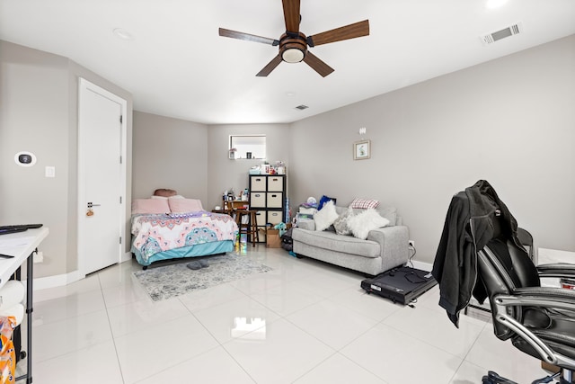 bedroom with ceiling fan, light tile patterned floors, and baseboards