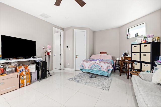 tiled bedroom with a ceiling fan
