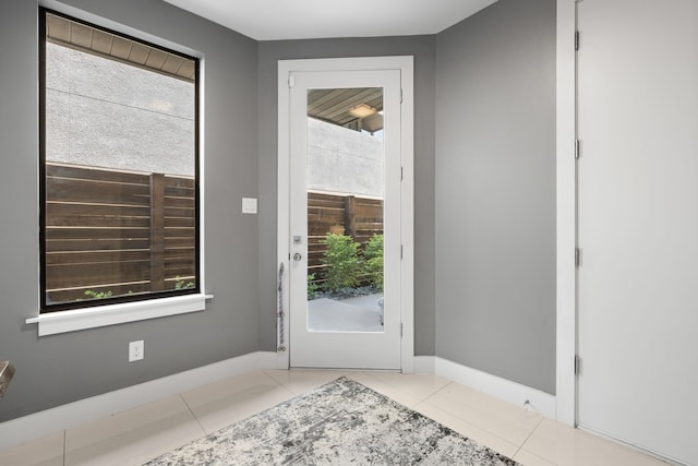 entryway with tile patterned floors and baseboards