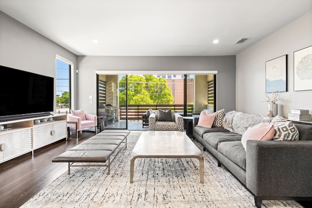 living room with wood finished floors and recessed lighting