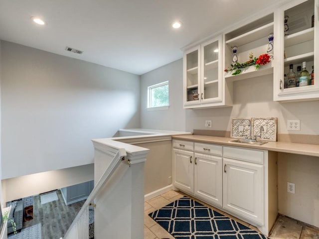 17607 Seedling Ct, Dallas, TX 75287 - kitchen featuring a sink, white cabinets, recessed lighting, glass insert cabinets, and light countertops