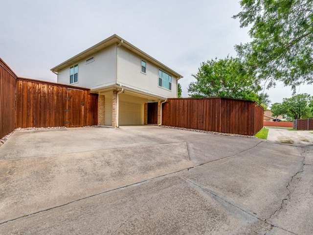 17607 Seedling Ct, Dallas, TX 75287 - view of home's exterior with an attached garage, concrete driveway, and fence