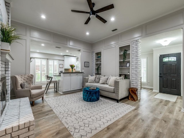17607 Seedling Ct, Dallas, TX 75287 - living room featuring ornamental molding, a ceiling fan, light wood finished floors, baseboards, and recessed lighting