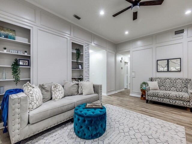 17607 Seedling Ct, Dallas, TX 75287 - living area featuring a decorative wall, ceiling fan, built in features, wood finished floors, and recessed lighting