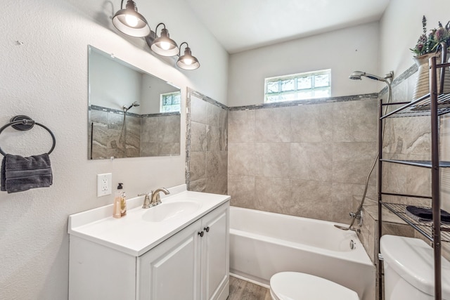 full bath with toilet, vanity, shower / tub combination, and wood finished floors