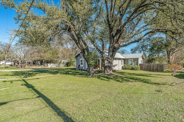 view of yard with a garage and fence