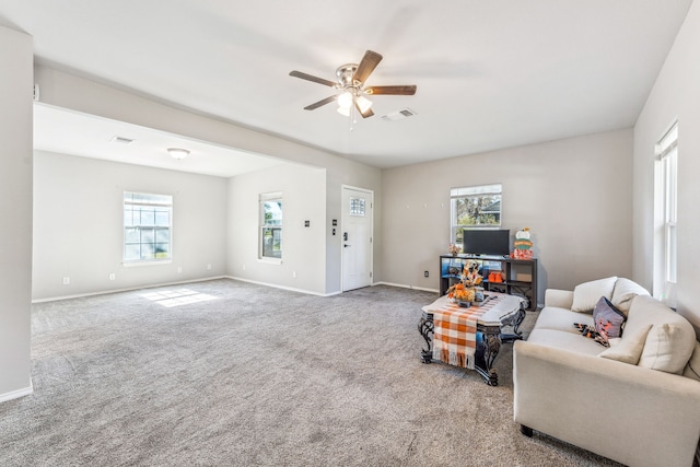 carpeted living area featuring visible vents, baseboards, and a ceiling fan