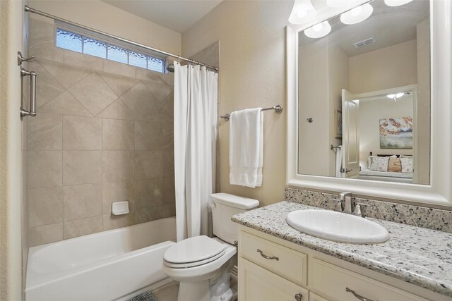 bathroom featuring vanity, toilet, visible vents, and shower / bath combo