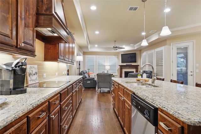 kitchen featuring a sink, black electric stovetop, visible vents, dishwasher, and a fireplace