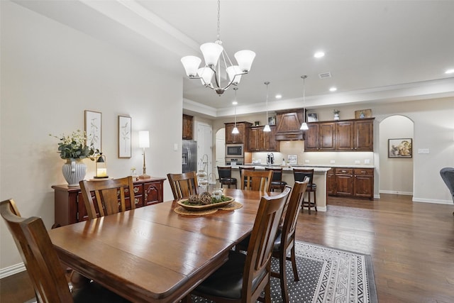 dining room featuring recessed lighting, dark wood finished floors, visible vents, a chandelier, and arched walkways