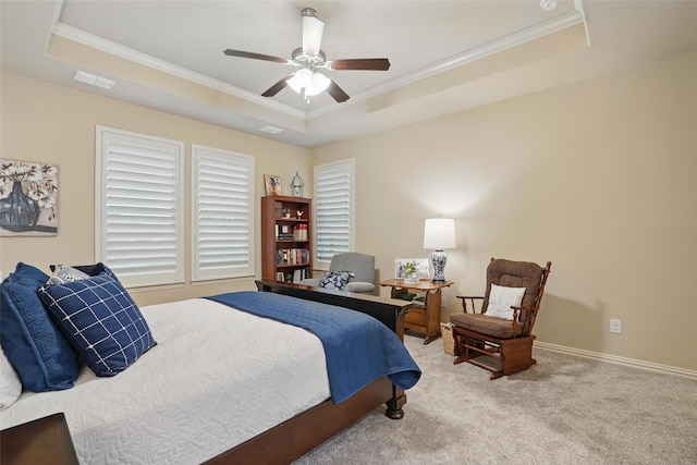 bedroom with ornamental molding, a tray ceiling, visible vents, and carpet