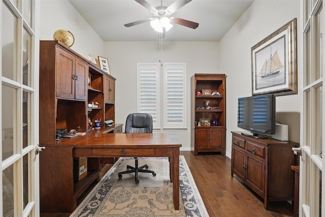 office area with baseboards, ceiling fan, and dark wood-style floors